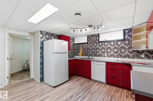 Kitchen with white appliances, a paneled ceiling, light wood-style floors, red cabinets, and open shelves - 12225 134 Street, Edmonton, AB - Indoor Photo Showing Kitchen