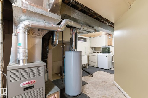 Utility room with water heater, heating unit, and washer and dryer - 12225 134 Street, Edmonton, AB - Indoor Photo Showing Basement