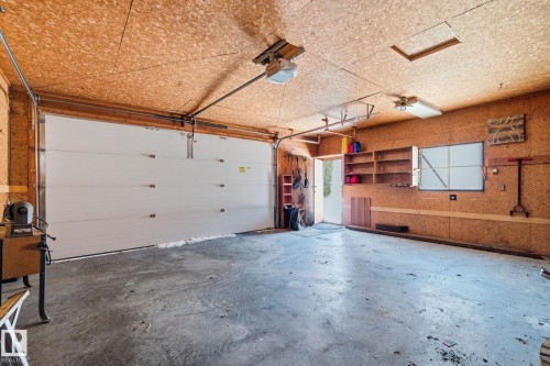 Garage with a garage door opener - 12225 134 Street, Edmonton, AB - Indoor Photo Showing Garage