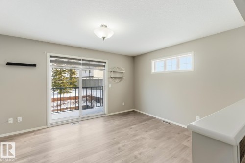 Unfurnished room with plenty of natural light and light wood finished floors - 16 3751 12 Street, Edmonton, AB - Indoor Photo Showing Other Room