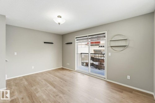 Empty room with light wood-style flooring - 16 3751 12 Street, Edmonton, AB - Indoor Photo Showing Other Room