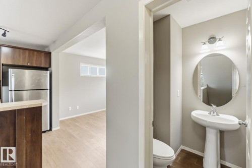 Half bathroom featuring light wood-type flooring and toilet - 16 3751 12 Street, Edmonton, AB - Indoor Photo Showing Bathroom