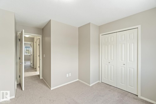 Unfurnished bedroom with light carpet and a closet - 16 3751 12 Street, Edmonton, AB - Indoor
