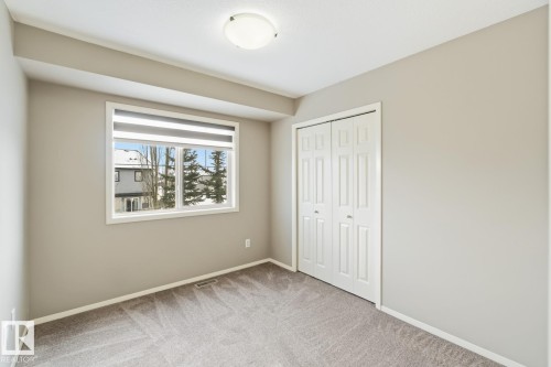 Unfurnished bedroom with light carpet and a closet - 16 3751 12 Street, Edmonton, AB - Indoor Photo Showing Other Room