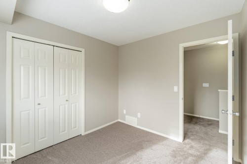 Unfurnished bedroom featuring a closet and light carpet - 16 3751 12 Street, Edmonton, AB - Indoor