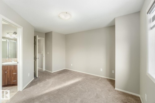 Unfurnished bedroom with light carpet and ensuite bathroom - 16 3751 12 Street, Edmonton, AB - Indoor Photo Showing Other Room