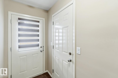 Doorway with baseboards and wood tiled floors - 16 3751 12 Street, Edmonton, AB - Indoor Photo Showing Other Room