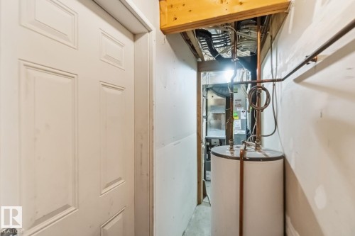 Utility room with water heater and heating unit - 16 3751 12 Street, Edmonton, AB - Indoor Photo Showing Other Room