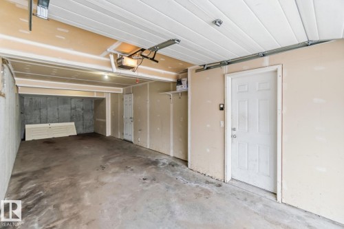 Garage featuring a garage door opener - 16 3751 12 Street, Edmonton, AB - Indoor Photo Showing Garage