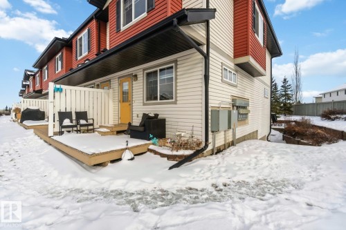 Snow covered rear of property featuring a wooden deck - 16 3751 12 Street, Edmonton, AB - Outdoor With Exterior