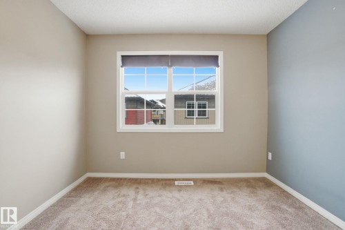 Unfurnished room featuring light colored carpet and baseboards - 71 4029 Orchards Drive, Edmonton, AB - Indoor Photo Showing Other Room