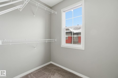 Walk in closet featuring carpet floors - 71 4029 Orchards Drive, Edmonton, AB - Indoor With Storage