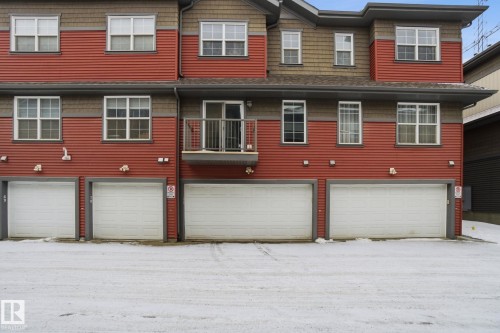 Rear view of property with a garage and a balcony - 71 4029 Orchards Drive, Edmonton, AB - Outdoor With Exterior