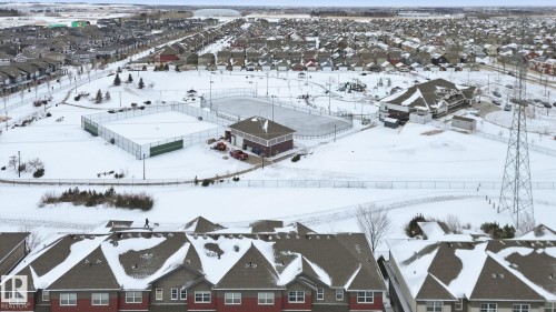 Snowy aerial view with a residential view - 71 4029 Orchards Drive, Edmonton, AB - Outdoor With View