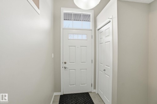 Doorway featuring baseboards - 71 4029 Orchards Drive, Edmonton, AB - Indoor Photo Showing Other Room