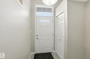 Doorway featuring baseboards - 71 4029 Orchards Drive, Edmonton, AB  - Indoor Photo Showing Other Room 