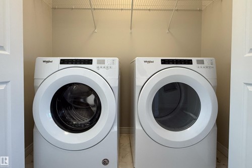 Laundry area with independent washer and dryer and baseboards - 1199 Watt Drive, Edmonton, AB - Indoor Photo Showing Laundry Room
