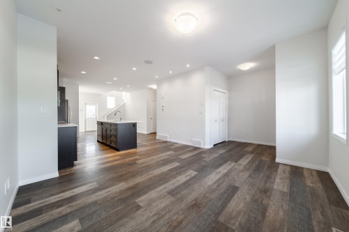 Unfurnished living room with dark wood-type flooring and recessed lighting - 1199 Watt Drive, Edmonton, AB - Indoor