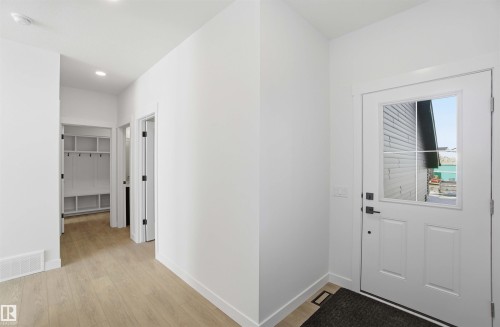Foyer with light wood finished floors and baseboards - 6949 176A Avenue, Edmonton, AB - Indoor Photo Showing Other Room