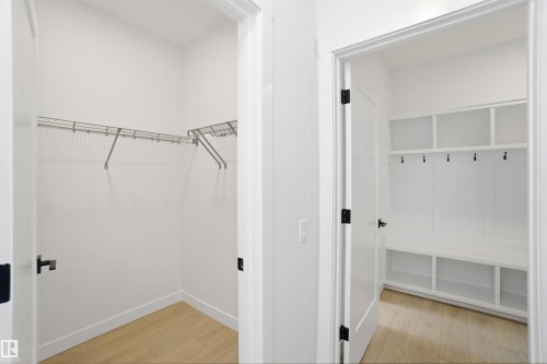 Walk in closet with light wood finished floors - 6949 176A Avenue, Edmonton, AB - Indoor With Storage