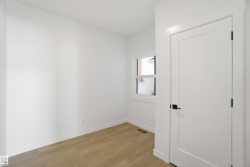 Unfurnished bedroom with light wood finished floors and baseboards - 6949 176A Avenue, Edmonton, AB - Indoor Photo Showing Other Room