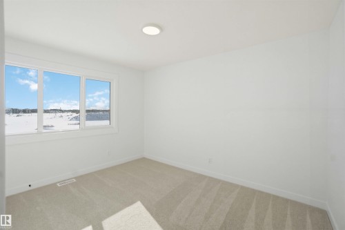 Empty room featuring light colored carpet and baseboards - 6949 176A Avenue, Edmonton, AB - Indoor Photo Showing Other Room