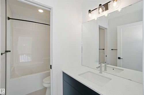 Full bathroom with vanity, bathtub / shower combination, light tile patterned flooring, and recessed lighting - 6949 176A Avenue, Edmonton, AB - Indoor Photo Showing Bathroom