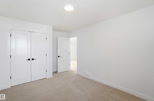 Unfurnished bedroom featuring light carpet and a closet - 6949 176A Avenue, Edmonton, AB - Indoor Photo Showing Other Room