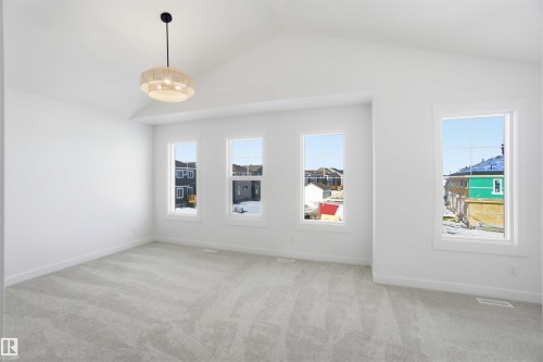 Spare room featuring light colored carpet and baseboards - 6949 176A Avenue, Edmonton, AB - Indoor Photo Showing Other Room