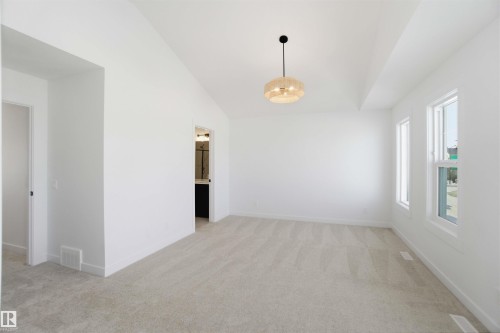 Spare room with light carpet and vaulted ceiling - 6949 176A Avenue, Edmonton, AB - Indoor Photo Showing Other Room
