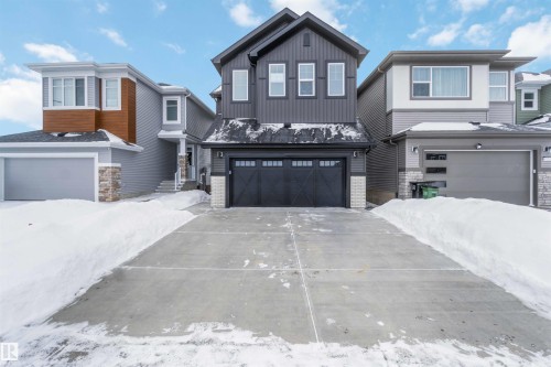 View of front of home featuring a garage and concrete driveway - 6949 176A Avenue, Edmonton, AB - Outdoor With Facade