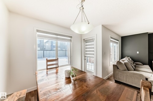 Dining space featuring baseboards and wood finished floors - 17357 8A Avenue, Edmonton, AB 