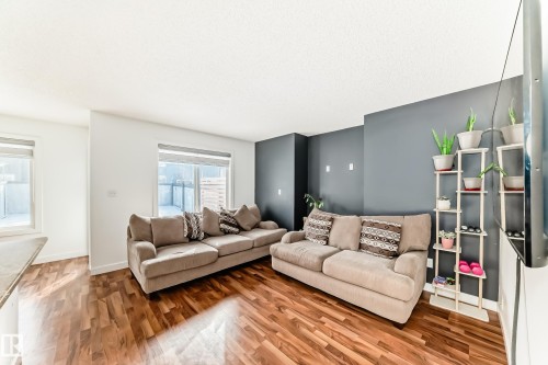 Living area with wood finished floors and baseboards - 17357 8A Avenue, Edmonton, AB 