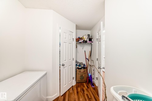 Hall with dark wood-style flooring - 17357 8A Avenue, Edmonton, AB 