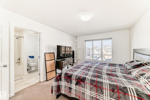 Bedroom with light carpet and connected bathroom - 17357 8A Avenue, Edmonton, AB 