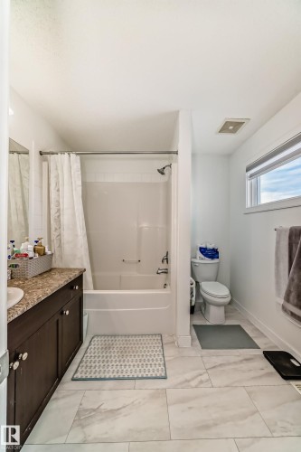 Bathroom featuring vanity and shower / bathtub combination with curtain - 17357 8A Avenue, Edmonton, AB 