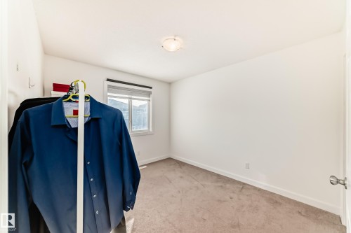Misc room featuring baseboards and light carpet - 17357 8A Avenue, Edmonton, AB 