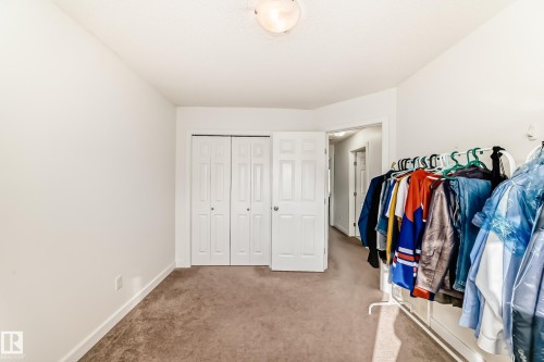 Walk in closet with light colored carpet - 17357 8A Avenue, Edmonton, AB 