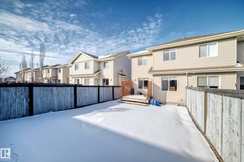 Fenced backyard featuring a residential view and a deck - 17357 8A Avenue, Edmonton, AB 