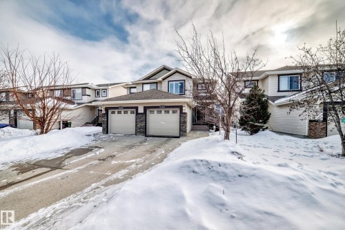 View of front of house with a garage and stone siding - 17357 8A Avenue, Edmonton, AB 
