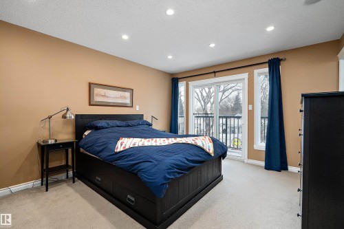 Bedroom featuring light colored carpet, access to outside, recessed lighting, and a textured ceiling - 10623 75 Avenue, Edmonton, AB - Indoor Photo Showing Bedroom