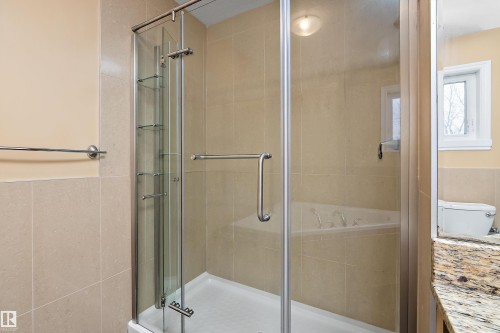 Full bath with tile walls, a garden tub, a stall shower, vanity, and a wainscoted wall - 10623 75 Avenue, Edmonton, AB - Indoor Photo Showing Bathroom