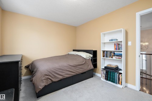Carpeted bedroom with baseboards and a textured ceiling - 10623 75 Avenue, Edmonton, AB - Indoor Photo Showing Bedroom