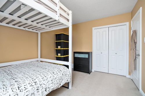 Bedroom with light carpet and a closet - 10623 75 Avenue, Edmonton, AB - Indoor Photo Showing Bedroom