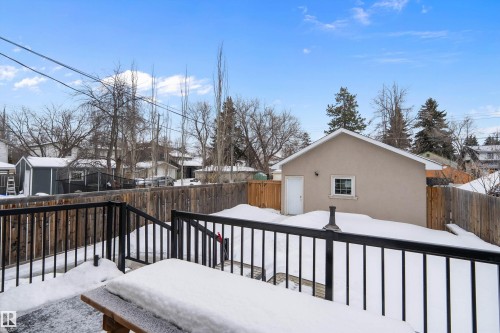 Snow covered deck with a fenced backyard and a residential view - 10623 75 Avenue, Edmonton, AB - Outdoor