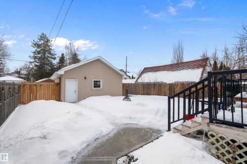 Yard covered in snow with a fenced backyard - 10623 75 Avenue, Edmonton, AB - Outdoor With Exterior