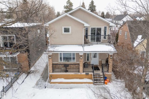 View of front of property with stucco siding, a porch, and a balcony - 10623 75 Avenue, Edmonton, AB - Outdoor