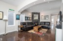 Living room featuring arched walkways, dark wood-type flooring, a fireplace, and recessed lighting - 10623 75 Avenue, Edmonton, AB  - Indoor Photo Showing Living Room With Fireplace 