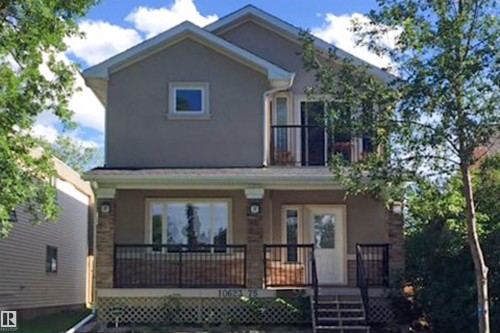 View of front of home with stucco siding, a balcony, and covered porch - 10623 75 Avenue, Edmonton, AB - Outdoor With Deck Patio Veranda