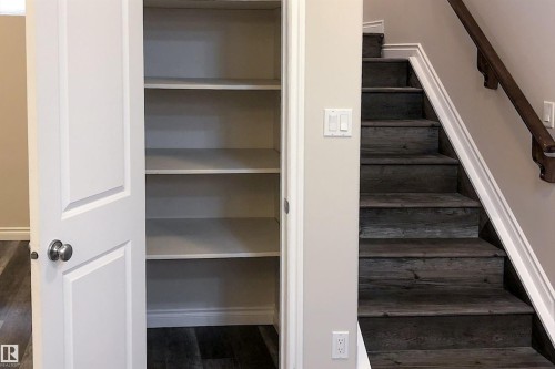 Stairway featuring wood finished floors and baseboards - 10623 75 Avenue, Edmonton, AB - Indoor Photo Showing Other Room